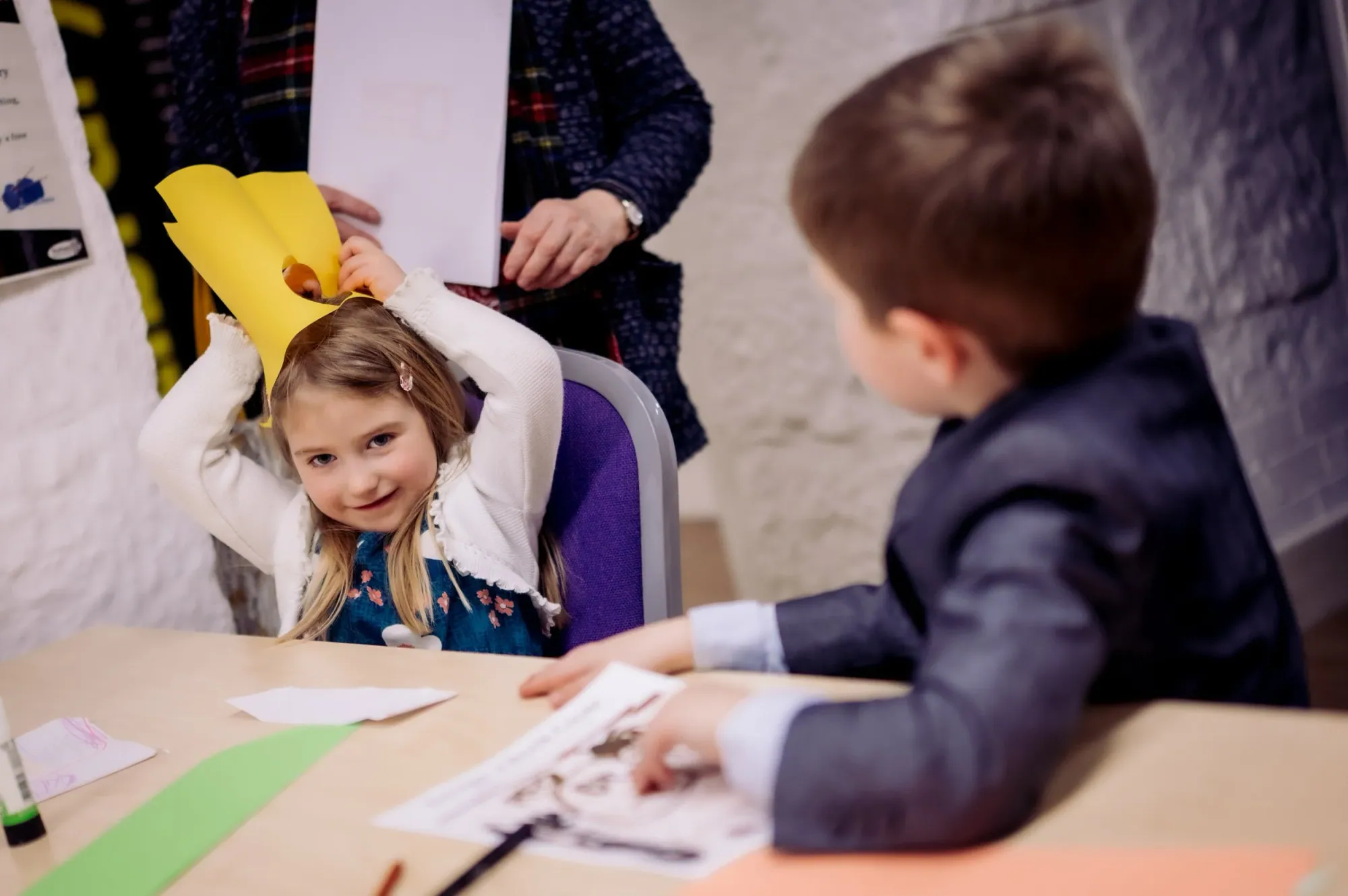 A girl showing her collage at a festival workshop