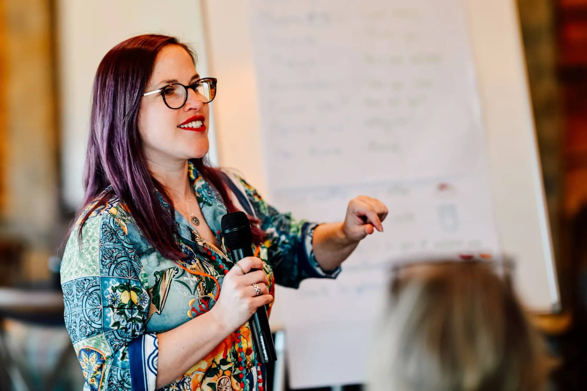 Hazel presenting to a group beside a flip chart